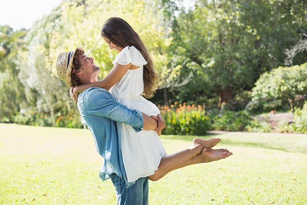 istock Hip young man lifting up his pretty girlfriend 498596279
