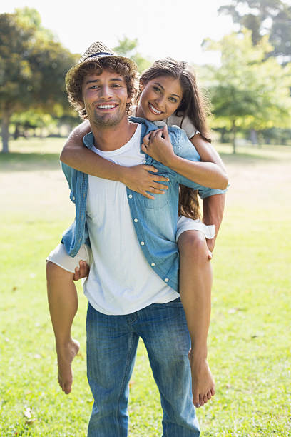 istock Hip young man giving a piggy back to his girlfriend 498596289
