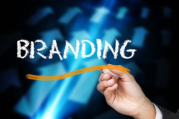 istock Businessman writing branding against arrows on black background 498596299