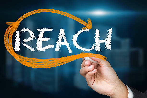 istock Businessman writing reach against cityscape on black background 498596309