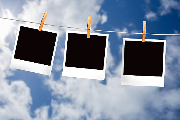 istock Composite image of clothes peg on line with instant photos 498597193