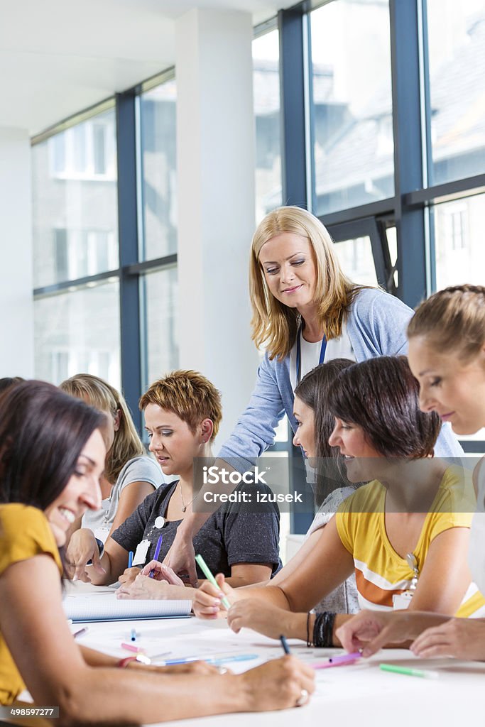 Group of women at the training Group of women attending a training, working together and discussing. Teacher Stock Photo