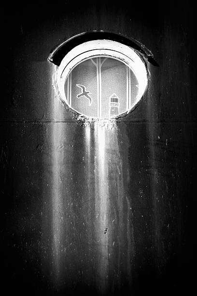 Home Sweet Home Porthole with a drape on a ship wall (b/w) titanic room stock pictures, royalty-free photos & images