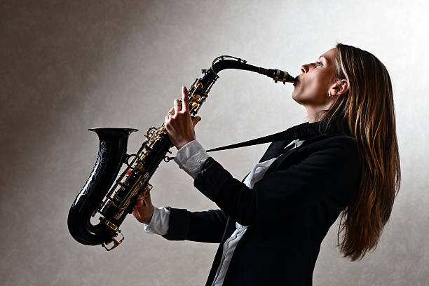 istock young beautiful woman with saxophone 498598193