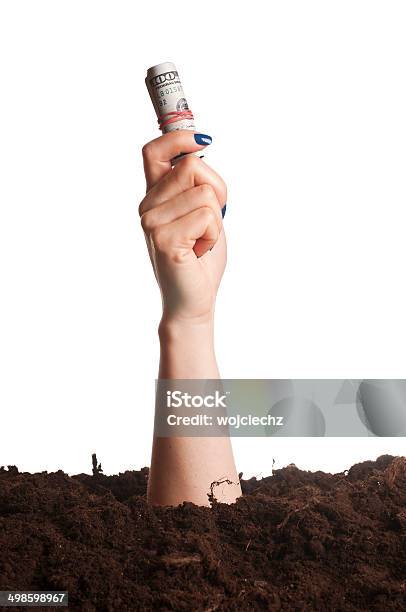 Hand Going Out Of The Ground Holding Hundred Dollar Bills Stock Photo - Download Image Now