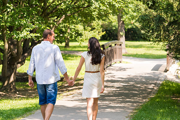 istock Rear view of walking couple in park 498599489