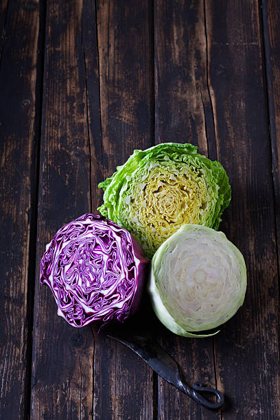 White cabbage, savoy and sweetheart cabbage, halved, on wood White cabbage, savoy and sweetheart cabbage, halved, on wood white cabbage stock pictures, royalty-free photos & images