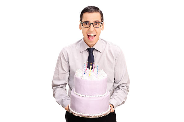 istock Cheerful young man holding a birthday cake 498600676