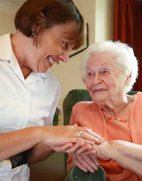 istock Care worker nurse caring for an elderly woman 498600813
