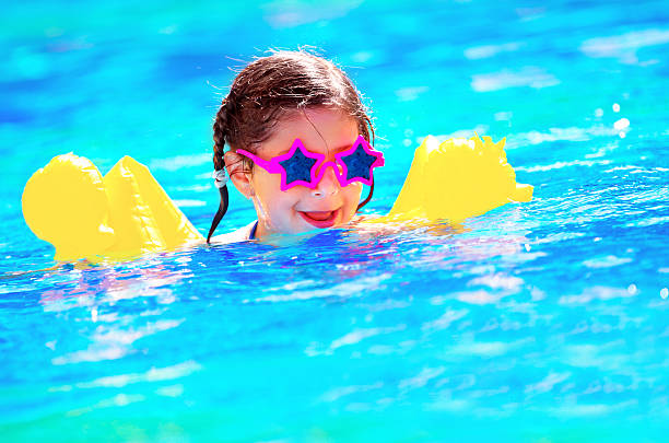 istock Cute little baby swiming in the pool 498600891
