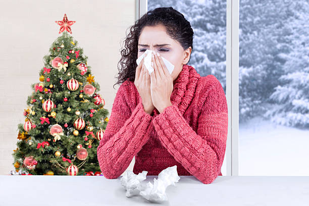 istock Woman blowing her nose at home 498603266