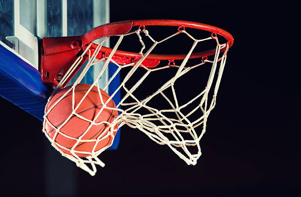 Basketball entering the hoop. Basketball in the hoop. making a basket scoring stock pictures, royalty-free photos & images