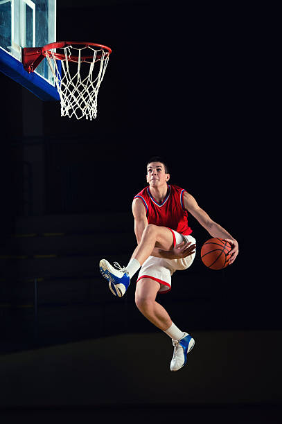 Basketball player jumping high towards the hop.