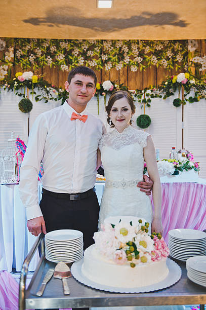 istock The newlyweds share a wedding cake for the guests 498605490