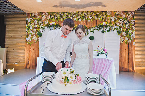 istock The newlyweds share a wedding cake for the guests 498605628