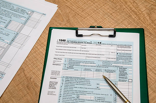 istock 1040 tax return form  on wooden table 498605816