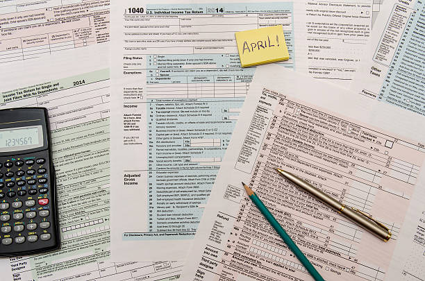 istock Federal Tax forms 1040 with pen, calculator and dollar 498606446