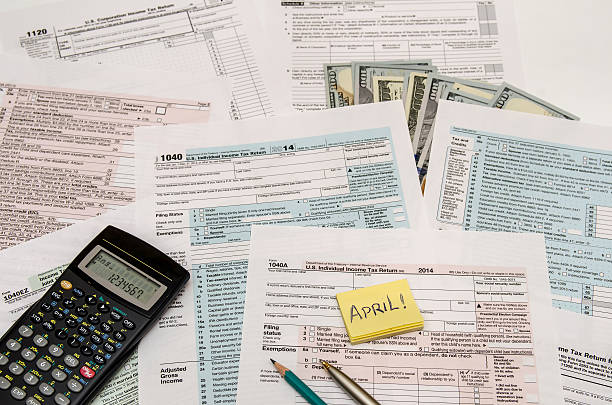 istock Federal Tax forms 1040 with pen, calculator and dollar 498606506
