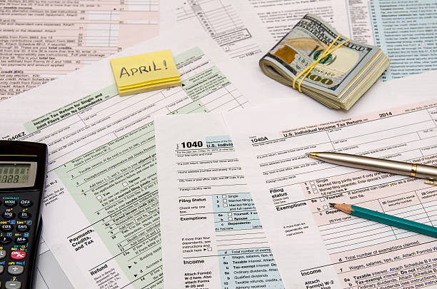 istock Federal Tax forms 1040 with pen, calculator and dollar 498606556