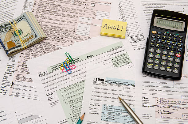 istock Federal Tax forms 1040 with pen, calculator and dollar 498606614