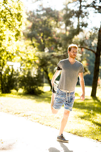 istock Young man running in the autumn park 498606738