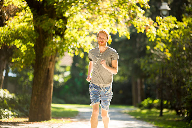 istock Young man running in the autumn park 498608002
