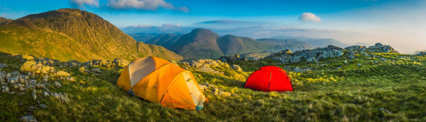 istock Tents wild camping on idyllic mountain summit panorama Lake District 498609040