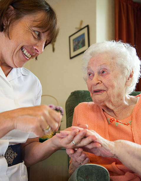 istock Care worker nurse caring for an elderly woman 498610941