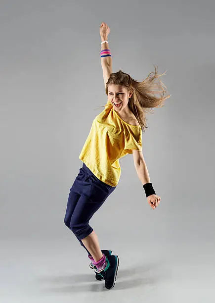 Energetic dancing woman screaming doing exercise. Young beautiful jazz girl in motion.