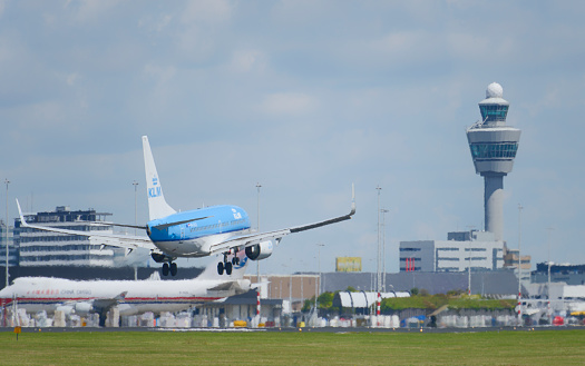 Schiphol, The Netherlands - June 22, 2014: KLM Royal Dutch Airlines Boeing 737 landing at Schiphol airport near Amsterdam in The Netherlands. KLM - Koninklijke Luchtvaart Maatschappij N.V. (Royal Dutch Airlines), is the flag carrier airline of the Netherlands.