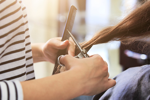 close-up of a women having her haircut, clean and beautiful hair.