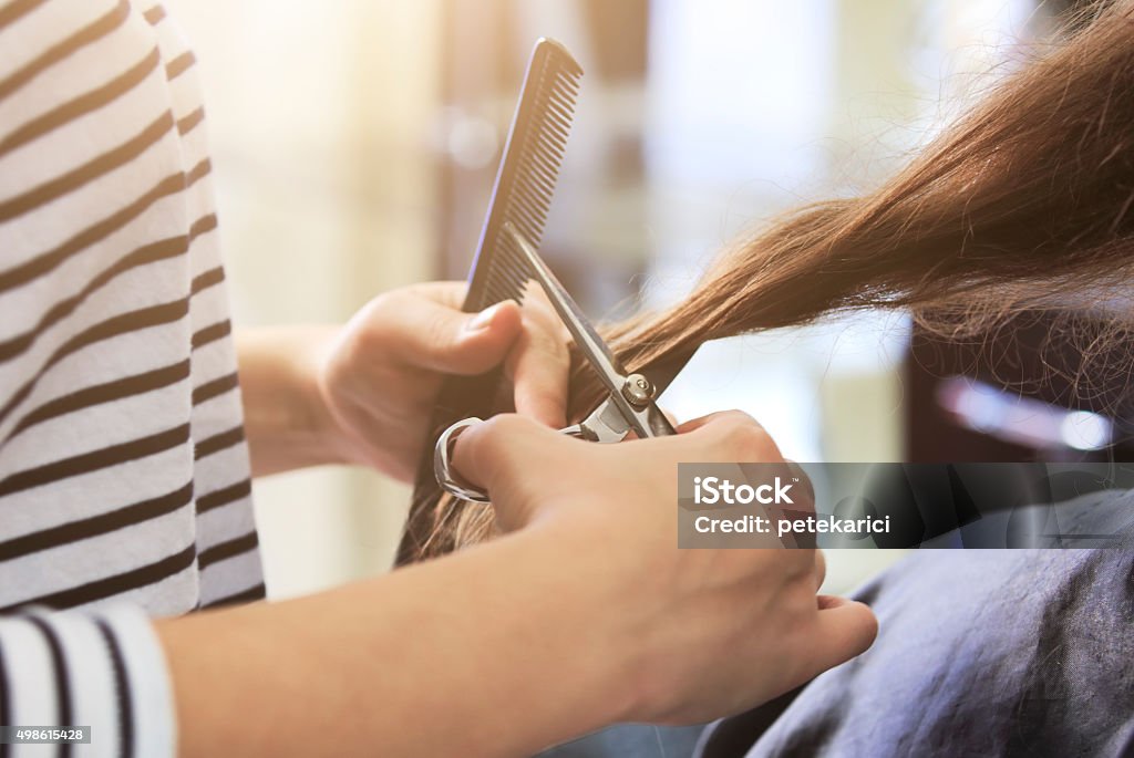 Hair cutting close-up of a women having her haircut, clean and beautiful hair. Hair Salon Stock Photo