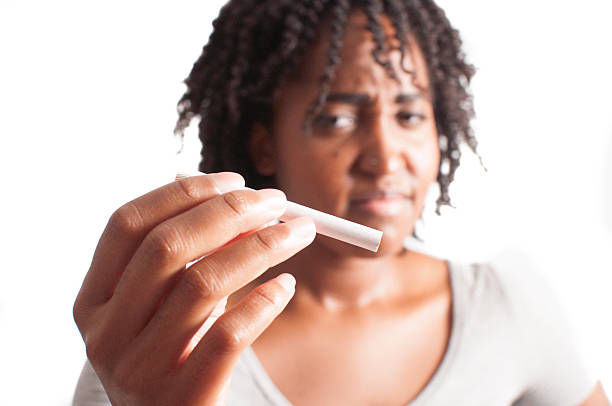 Woman thinking about smoking stock photo