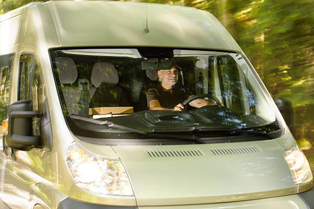 Postal delivery courier man drive cargo van stock photo