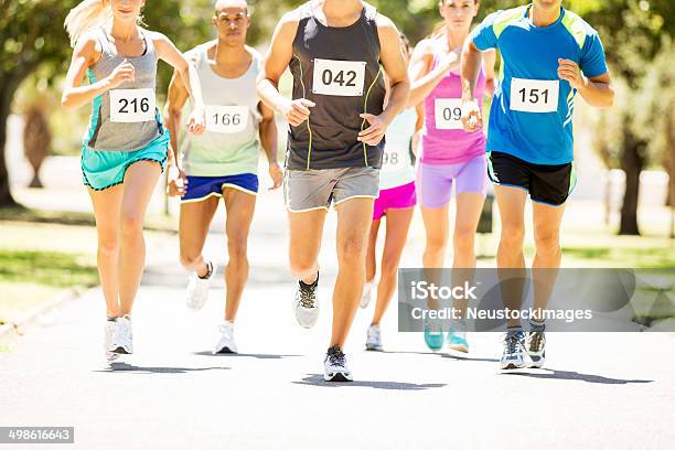 Men And Women Running Marathon At Park Stock Photo - Download Image Now - Running, Charity Benefit, Charity and Relief Work