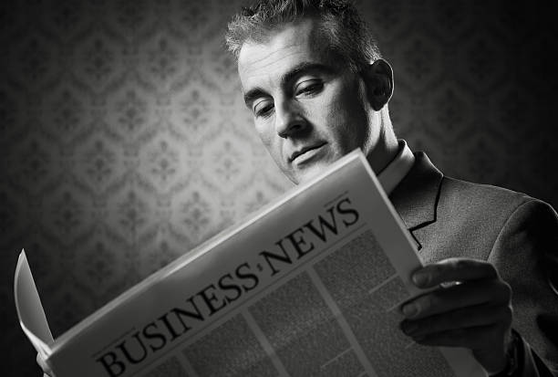 istock Businessman holding newspaper 498627181