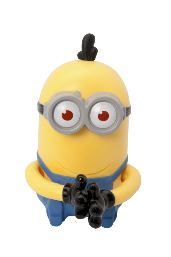 Adelaide, Australia - May 05, 2014: Minion figurine from the movie Despicable Me. This figurine was distributed with Mcdonalds Childrens Happy meals within australia to promote the movie.
