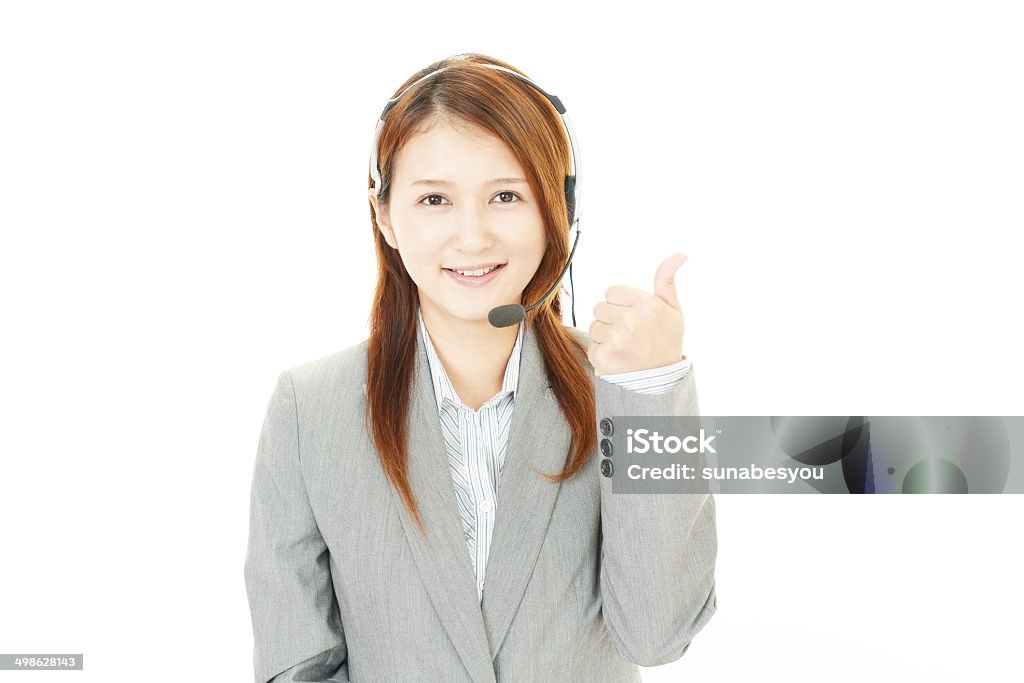 Smiling call center operator with thumbs up Portrait of a customer services operator Adult Stock Photo
