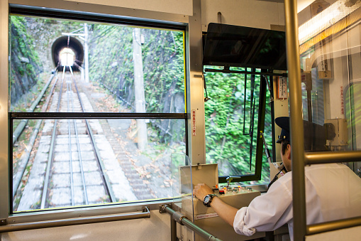 Tokyo, Japan - May 30, 2014: Driver in the Control cabin of a cable car at Mt. Takao in Tokyo, Japan.
