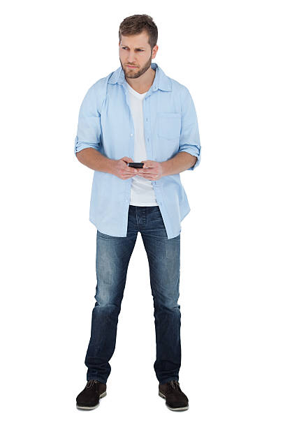 istock Serious man looking away and holding a phone 498630467