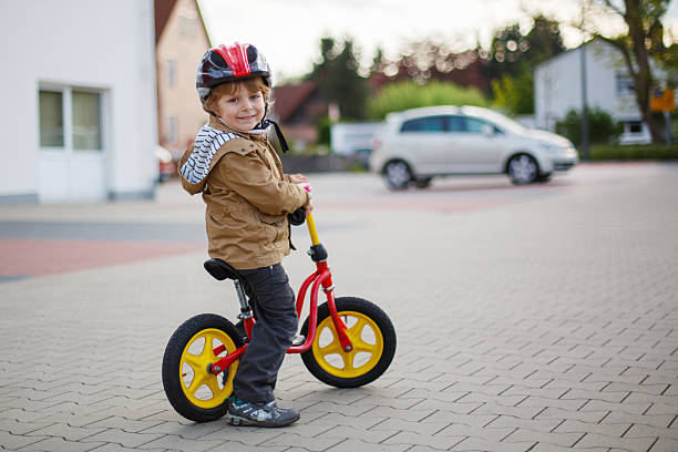 istock Little toddler boy learning to ride on his first bike 498630507