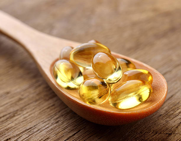 istock Fish oil capsules in a spoon 498631067
