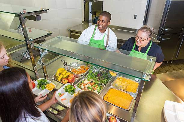 istock Students choosing healthy food options in school lunch line 498631387