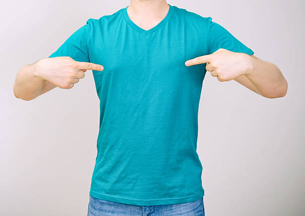 istock Man in turquoise t-shirt. Grey background. 498631869
