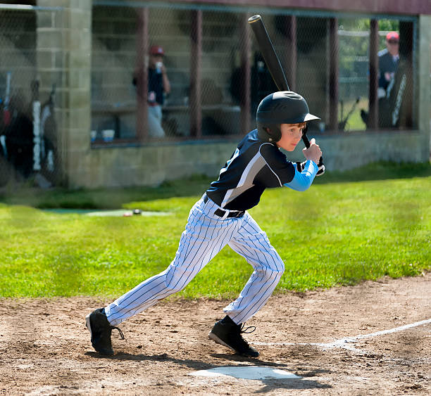 istock Little League Batter In Action at home plate 498632427