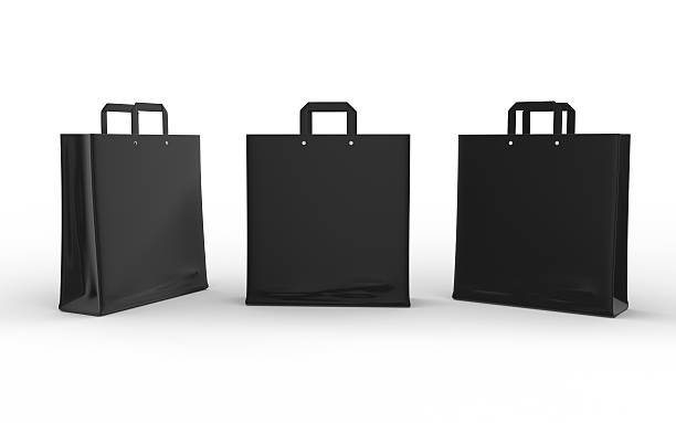 Black glossy paper bag isolated on white with clipping path stock photo