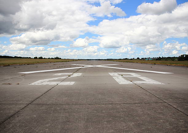 istock Airplane runway asphalt with number and cross 498633543