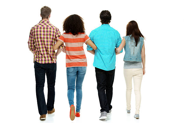 istock Rear view of four friends walking 498634177