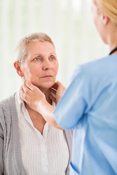 istock Doctor examining tyhroid glands 498634315
