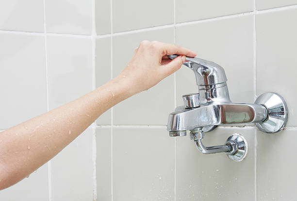 istock woman hand in bathroom 498644357